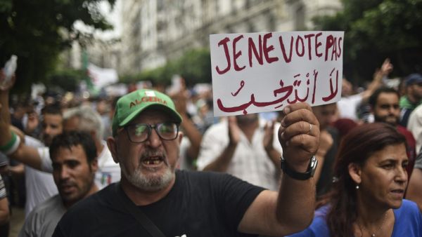 An Algerian protester holds a placard reading "I won't vote", during a demonstration against the ruling class in the capital Algiers on September 13, 2019, for the 30th consecutive Friday since the movement began. (AFP/ File Photo)