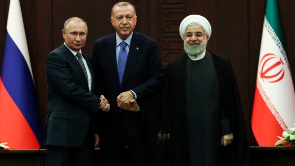 Turkish President Recep Tayyip Erdogan (C), Russian President Vladimir Putin (L) and Iranian President Hassan Rouhani (R) pose for photographs during a press conference following a trilateral meeting on Syria, in Ankara on September 16, 2019. (Adem ALTAN / AFP)