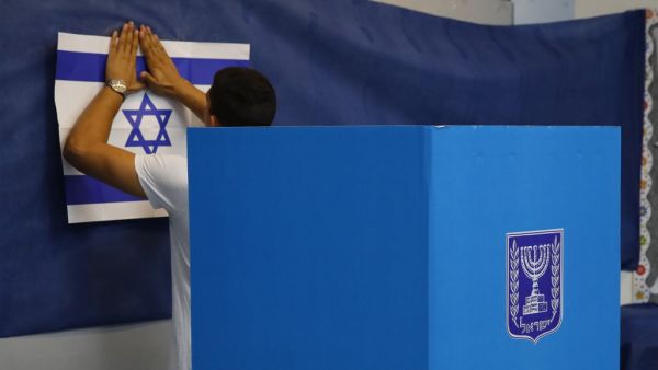 An Israeli man prepares a polling station during Israel's parliamentary election in Rosh Haayin, on September 17, 2019. Jack GUEZ / AFP