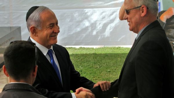 Israeli Prime Minister Benjamin Netanyahu (L) greets Benny Gantz, leader of Blue and White party, at a memorial ceremony for late Israeli president Shimon Peres, at Mount Herzl in Jerusalem on September 19, 2019. GIL COHEN-MAGEN / AFP