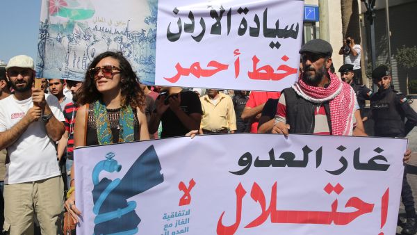 Jordanian protesters hold slogans reading, "no to normalisation with the Zionist enemy", "gas, enemy, occupation" during a protest in Amman in 2016 (AFP)