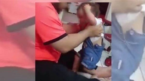 A screen grab from a video that went viral, purportedly showing a man beating a child (social media)