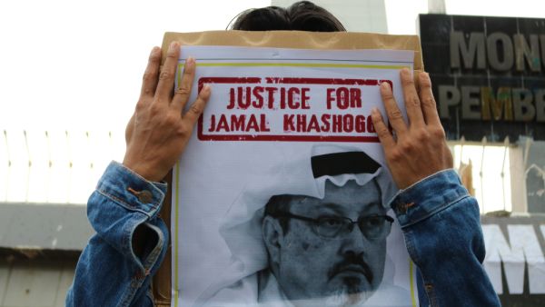 Humanitarian activists hold a poster with a picture of Jamal Khashoggi  (Shutterstock)	