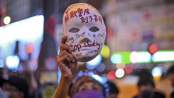 A woman holds a mask with slogans written on as protesters gather outside Mong Kok police station in Hong Kong on October 5, 2019. (AFP/ File Photo)