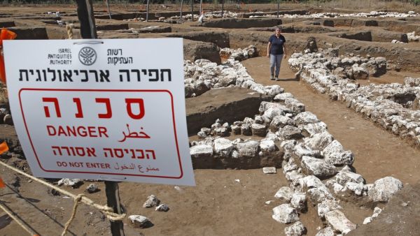 Israeli archaeologist Dina Shalem walks among stone structures at the archaeological site of En Esur (Ein Asawir) where a 5000-year-old city was uncovered, near the Israeli town of Harish on October 06, 2019. (JACK GUEZ / AFP)