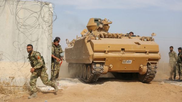 Pro-Turkish Syrian fighters drive an armoured personnel carrier across the border into Syria as they take part in an offensive against Kurdish-controlled areas in northeastern Syria launched by the Turkish military, on October 11, 2019. (AFP/ File Photo)