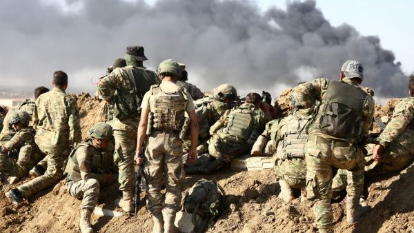 Turkish troops and Turkish-backed Syrian rebels gather outside the border town of Ras al-Ain on October 12, 2019, during their assault on Kurdish-held border towns in northeastern Syria. (AFP/ File Photo)