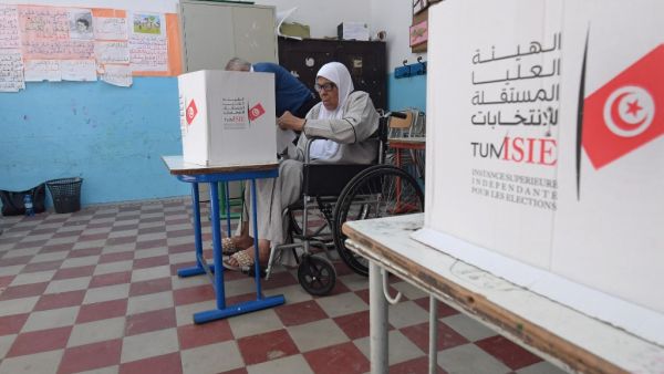 A Tunisian voter casts her ballot at a polling station in the capital Tunis on October 13, 2019 during the second round of the presidential election. Tunisians began voting today in a presidential runoff pitting conservative law professor Kais Saied against media magnate Nabil Karoui, who was released from prison just days earlier. (Fethi Belaid / AFP)