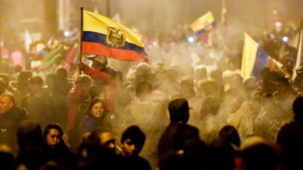 Indigenous people celebrate outside the Casa de la Cultura in Quito on October 13, 2019 after Ecuador's president and indigenous leaders reached an agreement to end violent protests. Luis ROBAYO / AFP