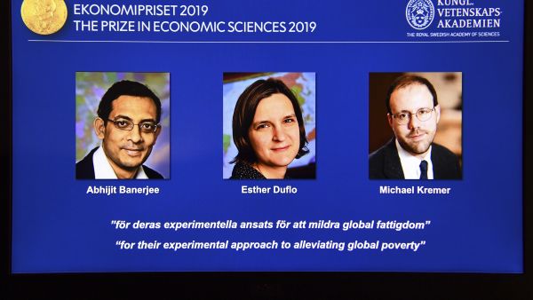 A computer screen displays the co-winners of the 2019 Sveriges Riksbank Prize in Economic Sciences in Memory of Alfred Nobel (L-R) Abhijit Banerjee, Esther Duflo and Michael Kremer during a press conference at the Royal Swedish Academy of Sciences in Stockholm, Sweden, on October 14, 2019. (AFP/ File Photo)