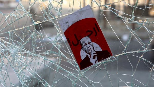 A placard depicting Lebanese President Michel Aoun with the words "Go Away" is seen amidst the debris at Riad al-Solh Square in the centre of the capital Beirut  (AFP)