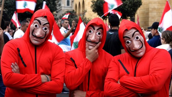 Lebanese men wearing outfits from Netflix TV series La Casa de Papelas take part in a rally in downtown Beirut on the fourth day of demonstrations against tax increases and official corruption, on October 20, 2019. (AFP/ File Photo)