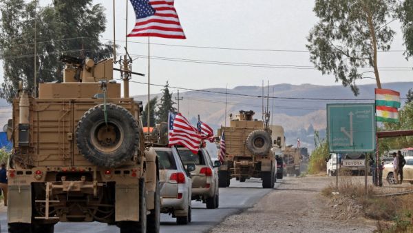 A convoy of US military vehicles arrives near the Iraqi Kurdish town of Bardarash in the Dohuk governorate after withdrawing from northern Syria on October 21, 2019. ( SAFIN HAMED / AFP)