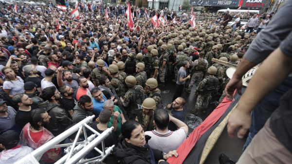Lebanese protesters stand facing army soldiers after they deployed on main roads to remove road blocks set up by demonstrators on October 23, 2019, in the area of Zouk Mosbeh north of the capital Beirut.  (AFP/ File Photo)