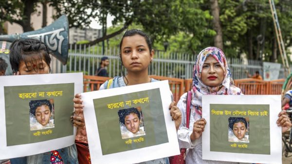 In this file photo taken on April 12, 2019 women hold placards with a photograph of schoolgirl Nusrat Jahan Rafi at a protest in Dhaka, following her murder by being set on fire after she had reported a sexual assault.  (AFP/ File Photo)
