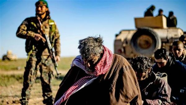 Men and boys suspected of being Daesh elements wait to be searched by members of the Kurdish-led Syrian Democratic Forces (SDF) after leaving the Daesh last holdout of Baghuz, Dayr al-Zawr Province, Syria, on March 1, 2019. (Photo by AFP)