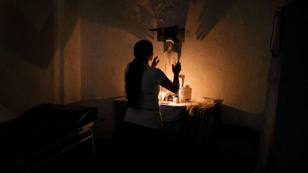 The spiritual leader spends time consulting with patients before performing rituals, as above, and prescribing them potions based on plants and fruits. (AFP/ File Photo)