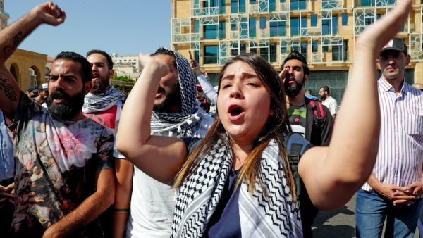 Lebanese protesters chants slogans during a demonstration in central Beirut's Martyr Square on October 6, 2019. Lebanese protested in the capital over increasingly difficult living conditions, amid fears of a dollar shortage and possible price hikes. (AFP)