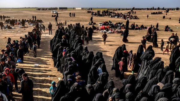 Civilians evacuated from ISIS's embattled holdout of Baghouz wait at a screening area held by the US-backed Kurdish-led Syrian Democratic Forces (SDF). (AFP/ File Photo)