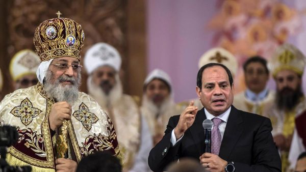 Egyptian president Abdel Fattah El Sisi speaks during a Christmas Eve mass as Coptic Pope Tawadros II looks on at the new Nativity of Christ Cathedral in Egypt's new administrative capital near Cairo on January 6, 2018. (Khaled Desouki / AFP)