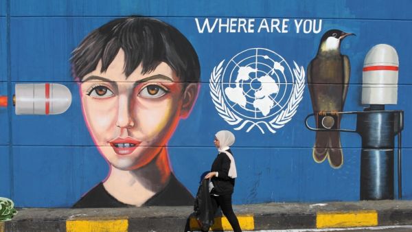 An Iraqi woman walks along a wall covered with a mural painting during an anti-government demonstration in the capital Baghdad's Tahrir square on November 4, 2019. (AFP/ File Photo)