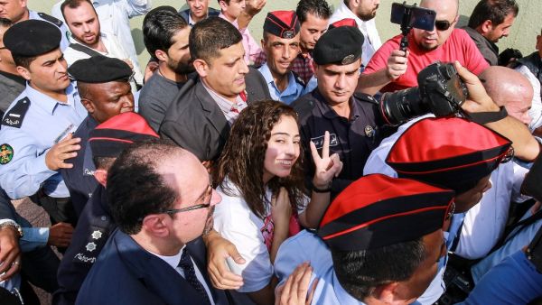 Hiba al-Labadi, a Jordanian national who was held by Israel for several months, flashes the victory gesture upon her release at the King Hussein Bridge (also known as Allenby Bridge) crossing between Israel and Jordan on November 6, 2019. (AFP/ File Photo)
