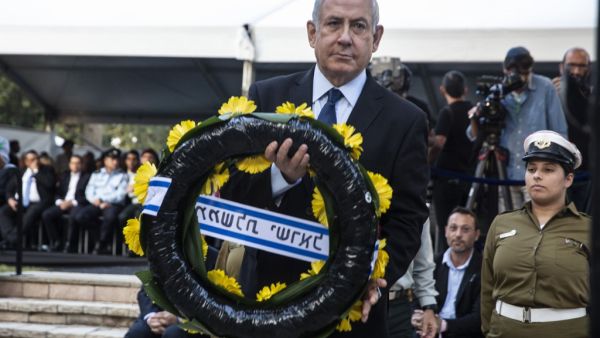 Israeli Prime Minister Benjamin Netanyahu places a wrath on the grave of former Israeli prime minister Yitzhak Rabin during a state memorial ceremony at Mount Herzl in Jerusalem on November 10, 2019. (HEIDI LEVINE / POOL / AFP)