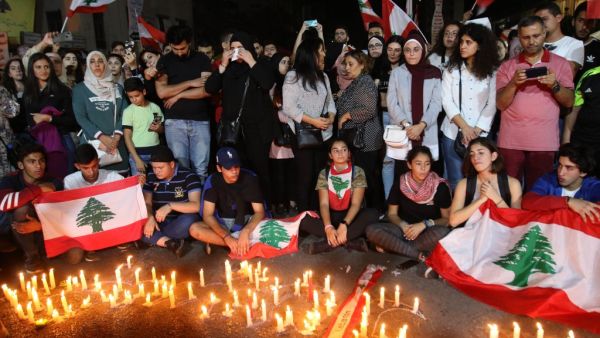 Lebanese demonstrators hold a candle light vigil in the the southern Lebanese city of Sidon (Saida) on November 13, 2019, for Alaa Abu Fakhr (photo), killed the day before during ongoing anti-government protests. Fakhr died of gunshot wounds overnight as the army opened fire to disperse protesters south of the capital, the second such death since the start of the largely peaceful protests. Mahmoud ZAYYAT / AFP