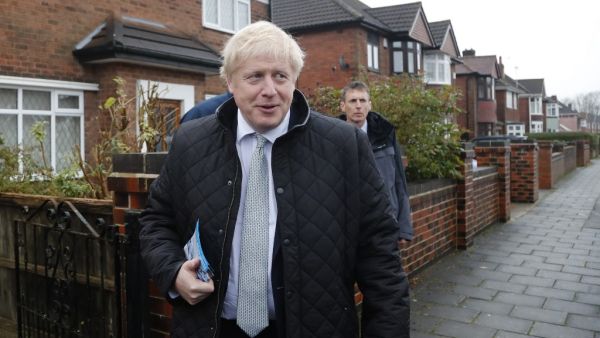 Britain's Prime Minister Boris Johnson (R) meets voters as he canvasses on the General Election campaign trail in Mansfield, Nottinghamshire on November 16, 2019. Britain goes to the polls on December 12, 2019. (Frank Augstein / POOL / AFP)