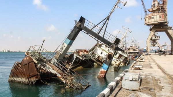 This picture taken on November 16, 2019 shows a view of a partially sunken ship by a pier at the fishing port of Yemen's second city of Aden in the Tawahi district overlooking the Gulf of Aden, which fell under the control of the Yemeni "Institution Protection Brigade". Saleh Al-OBEIDI / AFP