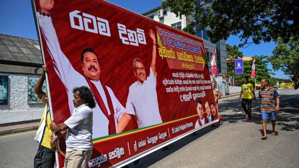 Supporters of Sri Lanka Podujana Peramuna (SLPP) party presidential candidate Gotabaya Rajapaksa carry cut-out placards to celebrate in Colombo on November 17, 2019. (AFP)