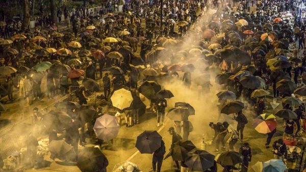 Protesters react as police fire tear gas while they attempt to march towards Hong Kong Polytechnic University in Hung Hom district of Hong Kong on November 18, 2019. (AFP/ File Photo)
