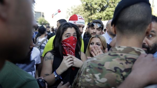 Lebanese protesters stand next to security forces near parliament headquarters in the capital Beirut on November 19, 2019. (AFP/ File Photo)