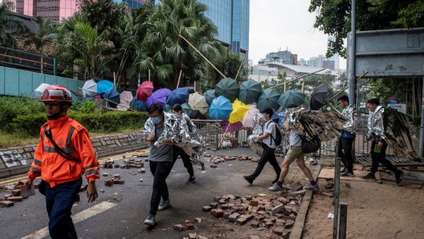 Protesters are escorted out of the main entrance to Hong Kong Polytechnic University campus in the Hung Hom district in Hong Kong on November 19, 2019. (AFP/ File Photo)