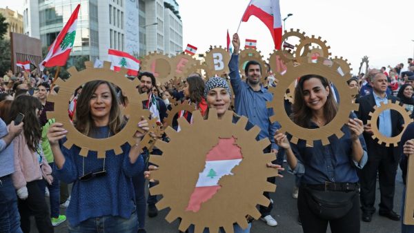 Lebanese demonstrators take part in a civilian Independence Day parade in Beirut's Martyr Square on November 22, 2019, more than a month into protests demanding an overhaul of the entire political system. (AFP/ File Photo)