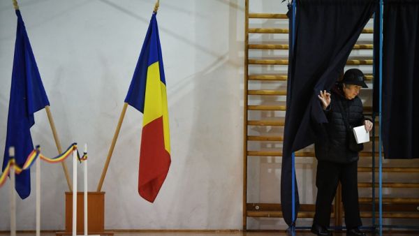 A woman leaves a voting booth on the second round of presidential elections at a poll station in Bucharest November 24, 2019. (AFP/ File Photo)