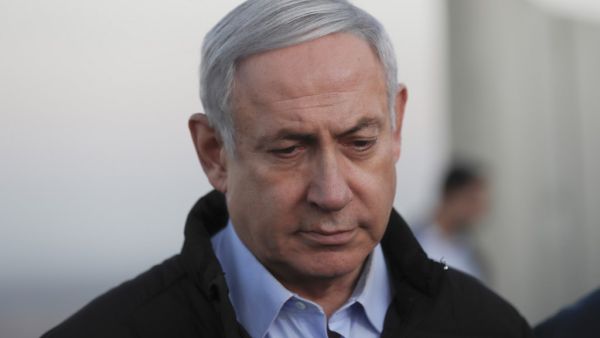 Israel's Prime Minister Benjamin Netanyahu looks on during a visit to an army base in the Israeli-annexed Golan Heights overlooking Syrian territory, on November 24, 2019. ATEF SAFADI / POOL / AFP