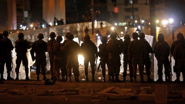 Lebanese army soldiers deploy as supporters of the Shiite Hezbollah and Amal groups arrive on scooters amid clashes with anti-government protesters in the capital Beirut (AFP)