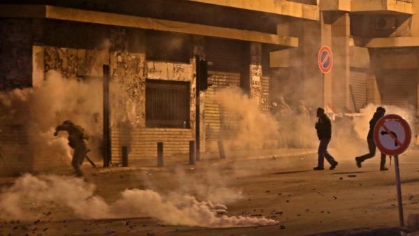 A Lebanese army soldier is seen surrounded by tear gas, amid clashes between supporters of the Shiite groups Hezbollah and Amal, and anti-government protesters in the capital Beirut, on November 25, 2019. (AFP/ File Photo)