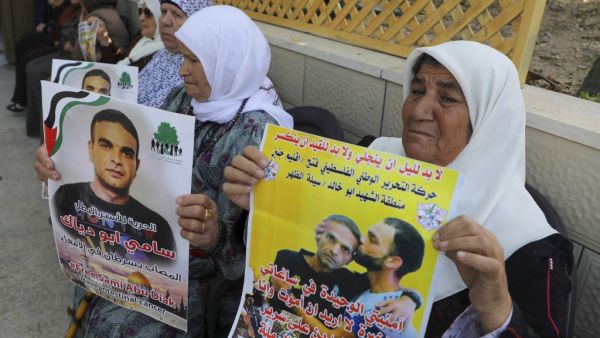 Relatives of Palestinian prisoner Sami Abu Diyak mourn at his house in Saylat al-Dahr town, south of Jenin city in the West Bank, on November 26, 2019, after news of his death of cancer in an Israeli jail. The death, which sparked Palestinian accusations of neglect, comes amid heightened tension with protests already scheduled in multiple places in the occupied West Bank today. Jaafar ASHTIYEH / AFP