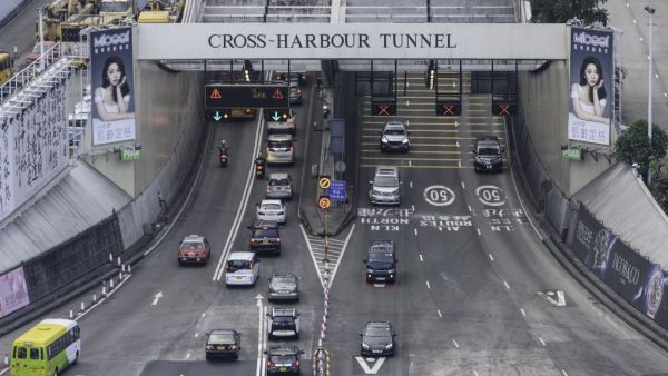 Commuters drive through the reopened Cross Harbour Tunnel, a key route between the Kowloon peninsula, in Hong Kong early on November 27, 2019, after protesters stationed in and around the Hong Kong Polytechnic University closed the link on November 13. (Anthony WALLACE / AFP)