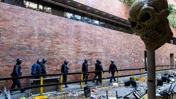 Hong Kong Police Explosive Ordnance Disposal Bureau (EOD) personnel search for explosives and chemicals at the Hong Kong Polytechnic University in the Hung Hom district of Hong Kong on November 28, 2019, over a week after police surrounded the building while pro-democracy protesters were still barricaded inside. ANTHONY WALLACE / AFP