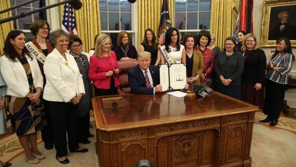 President Donald Trump poses after signing H.R. 2423, the Womens Suffrage Centennial Commemorative Coin Act, in the Oval Office at the White House on November 25, 2019 in Washington, DC. ( Mark Wilson/Getty Images/AFP)