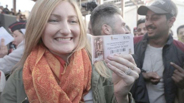 Alison Carey, from California, displays her permanent pass to Petra after becoming the millionth visitor to the ancient city this year on Thursday (Petra photo)