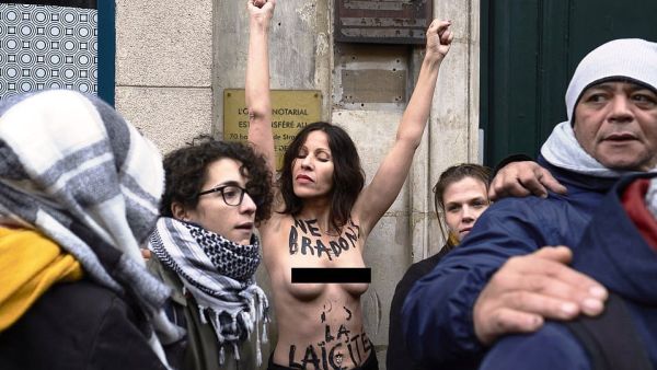 A topless woman, who had 'we're not promoting secularism' written on her chest, also joined the protest but appears to be from the feminist group Femen protesting for a secular society  (dailymail)