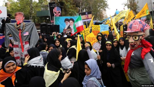 With anti-American slogans and effigies mocking U.S. President Donald Trump, thousands rally outside the former U.S. Embassy in Tehran on November 4. (AFP/ File Photo)