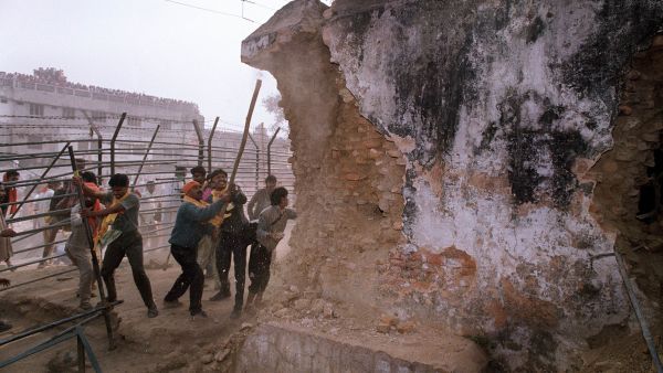 On Dec. 6, 1992, Hindu attackers hit the wall of the 16th century Babri Masjid with iron rods, part of a mob that tore down the mosque. Thousands were killed in rioting that followed the mosque's destruction. (Douglas E. Curran/AFP/Getty Images)