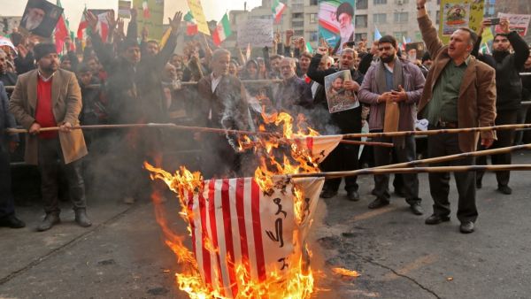 Iranian pro-government demonstrators burn makeshift US flags as they gather in the capital Tehran's central Enghelab Square on November 25, 2019, to condemn days of "rioting" that Iran blames on its foreign foes. (AFP/ File Photo)