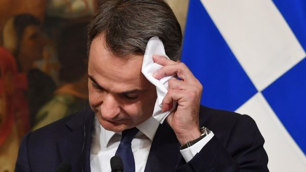 Greek Prime Minister Kyriakos Mitsotakis wipes his forehead during a joint press conference with his Italian counterpart following their meeting at Palazzo Chigi on November 26, 2019 in Rome. Andreas SOLARO / AFP