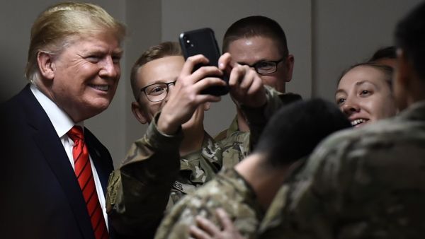 US President Donald Trump poses for selfies during a Thanksgiving dinner with US troops at Bagram Air Field during a surprise visit on November 28, 2019 in Afghanistan. Olivier Douliery / AFP